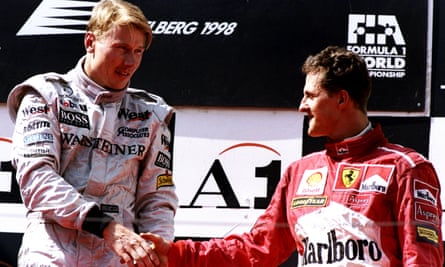 Mika Häkkinen is congratulated on the podium by Michael Schumacher at the 1998 Austrian Grand Prix