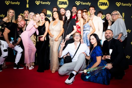 Attendees at the event pose on the red carpet.