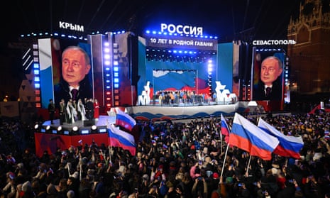 Vladimir Putin addresses a crowd at a rally in Moscow on 18 March.
