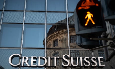 A signs of Swiss bank Credit Suisse is seen in Basel, on the eve of the general meeting of shareholders following the takeover by UBS