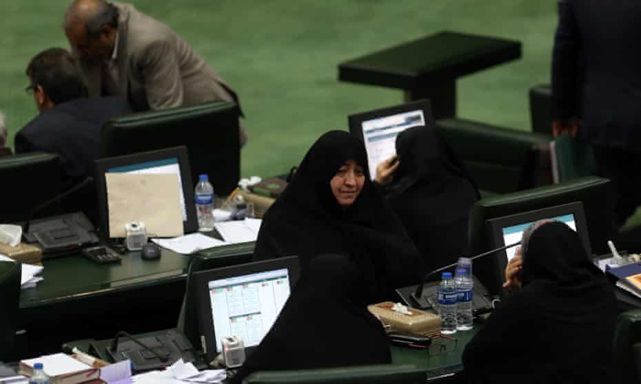 Iranian lawmakers take part during a parliament session in Tehran, Iran, on Tuesday at which they passed a bill labeling US forces in Middle East as terrorist.
