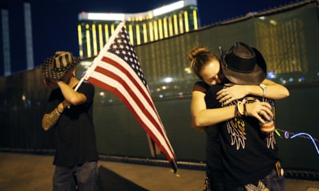 People embrace on the first anniversary of the mass shooting in Las Vegas, on 1 October 2018. 