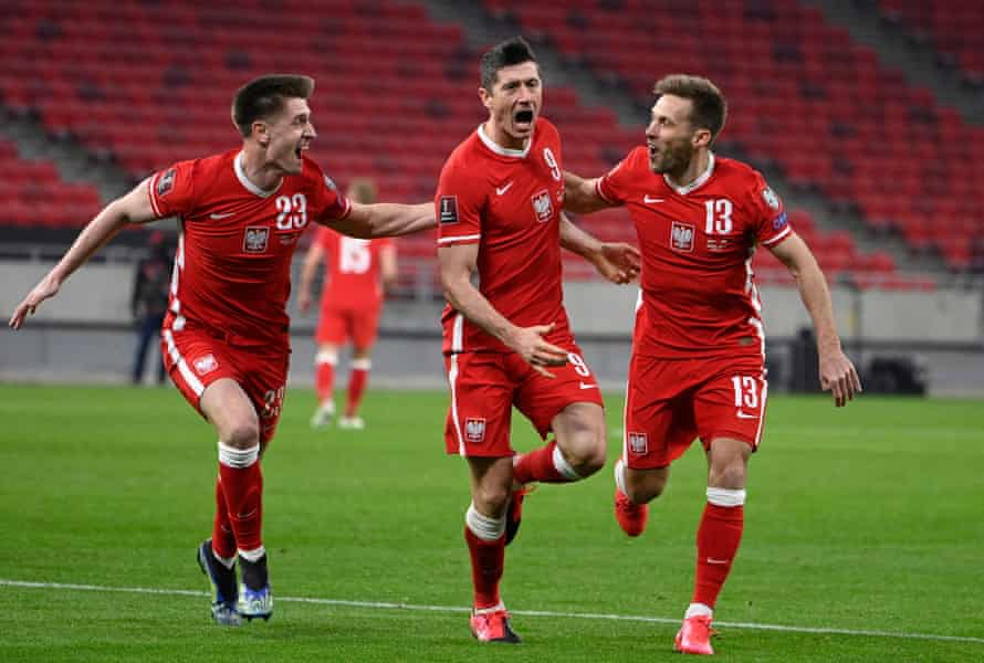 Robert Lewandowski is chased by his Poland teammates after his fine late equaliser in Budapest.