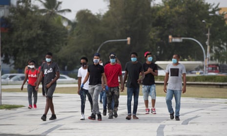 Young people wearing masks walk through Santo Domingo, Dominican Republic, 22 June, 2020.
