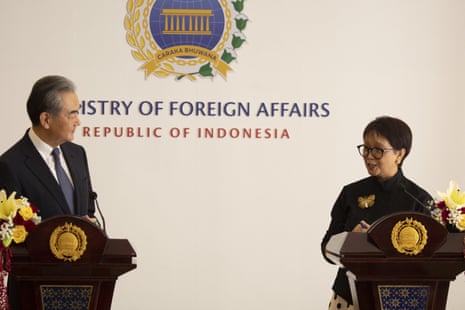 Chinese foreign minister Wang Yi and Indonesia’s minister of foreign affairs Retno Marsudi stand looking at each other as they stand behind lecterns in front of a sign that reads: 'The ministry of foreign affairs, Republic of Indonesia.'