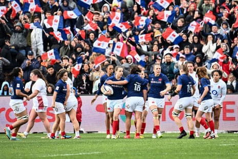 Menager celebrates in front of the home crowd after scoring a try for France.