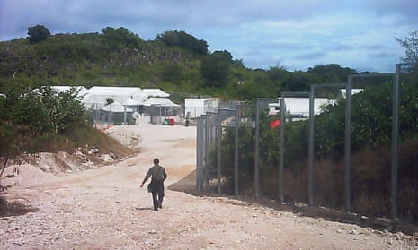 A guard walks towards the entrance of the Nauru detention centre in May 2015. 