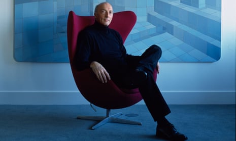 Monsoon founder Peter Simon sitting on a maroon chair, dressed in dark blue, with different shades of pale blue carpet, wall and painting