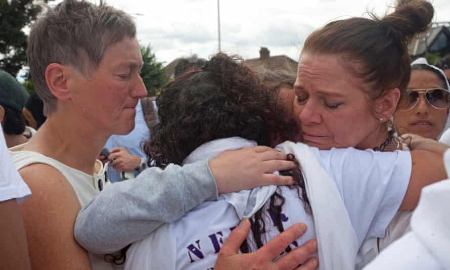 Members of the tearful crowd support each other at the vigil.