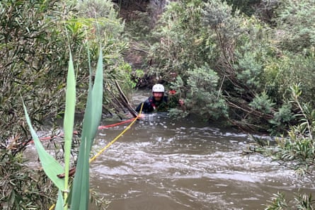 An emergency worker attempts a rescue at flooded Buchan caves campground.