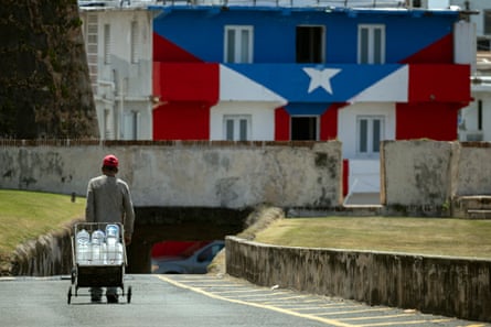 A man transports h2o containers