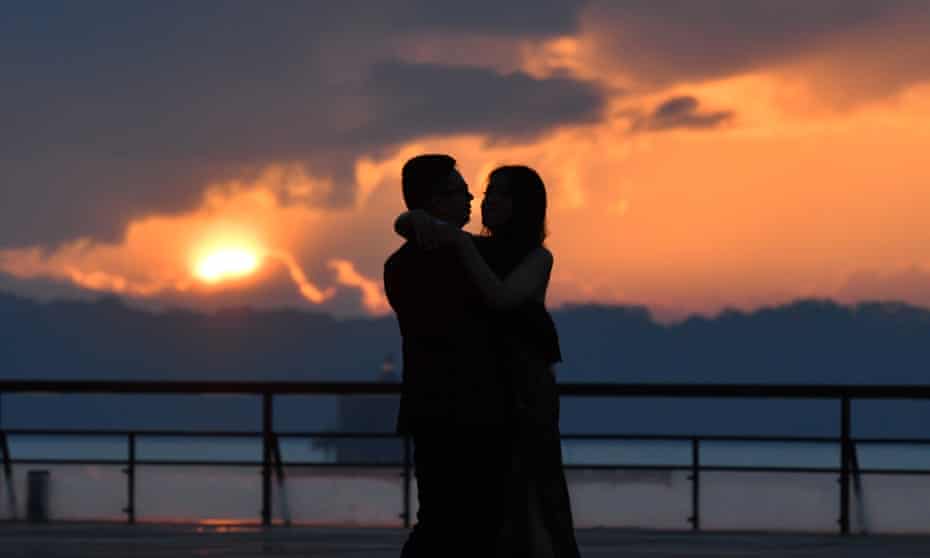 silhouette of a couple hugging against a sunset