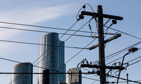 Electricity poles and wires against the backdrop of buildings in Melbourne, Victoria's, CBD