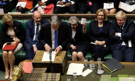 Philip Hammond being given some cough sweets by Theresa May as he delivers his Budget on Wednesday.