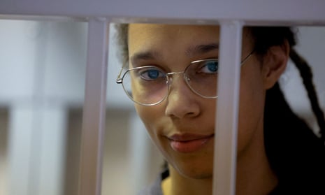 Brittney Griner stands inside a defendants' cage before a court hearing in Khimki near Moscow.