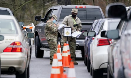 National guard personnel check in people as they wait to receive a Covid vaccination on 26 February 2021, in Shelbyville, Tennessee.