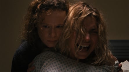 Imogen Poots crying with Thora Birch standing behind holding her