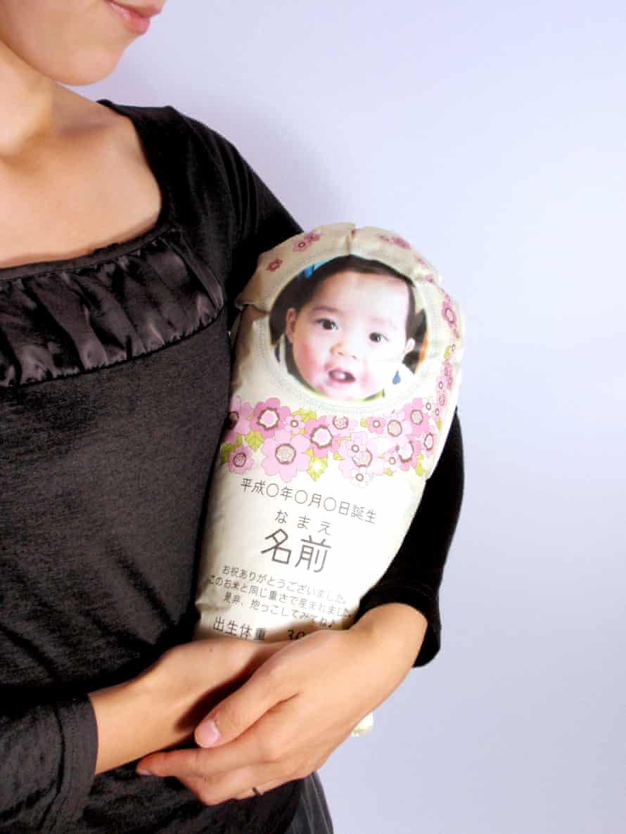 Woman cradling rice baby.