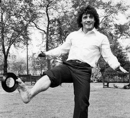 a man hold a seven-inch record between his toes