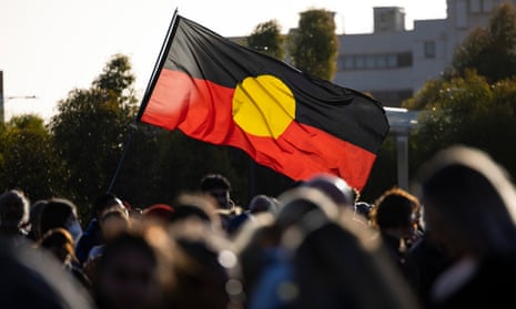 The Aboriginal flag held above a crowd of people in Perth