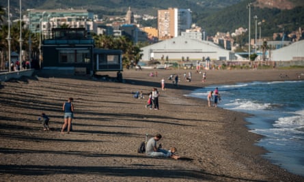 Children and parents enjoy Misericordia beach in Malaga, Spain.