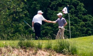 Donald Trump shakes hands during a round of golf on Saturday