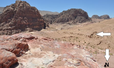 Overview of the monumental platform, looking south-east. Jabal an-Nmayr is is indicated by the left-facing arrow, and the slope of ‘South Ridge’ with agricultural terracing by the down-facing arrow.