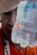ICE detainee holds up water bottle that appears to be contaminated with worm-like creatures