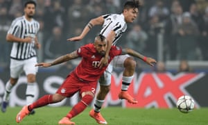 Arturo Vidal of Bayern Muenchen and Paulo Dybala of Juventus battle for the ball.