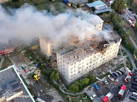 Smoke rises from damaged buildings, at the site of the Russian drone strike in Kharkiv, Ukraine.