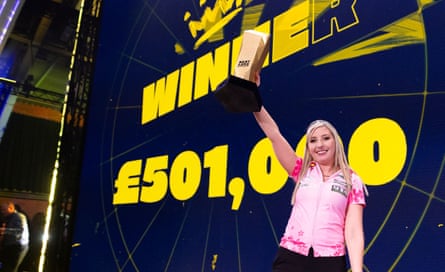 Fallon Sherrock on stage with the caption ‘Winner £501,000’ on the wall behind her.