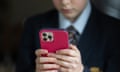 In this photo illustration, a 12-year-old schoolboy looks at a iPhone screen.