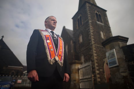 A member of the Portadown District Loyal Orange Lodge (LOL) No 1 outside Drumcree Church, where the marchers have been waiting