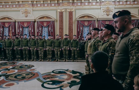Ukrainian soldiers standing to attention inside the palace