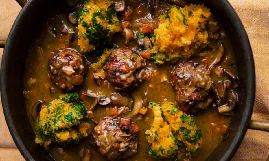 Dark meatballs in a rich sauce in a pan