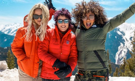 Emily Atack, Ruby Wax and Mel B pose, smiling, in front of a mountain landscape
