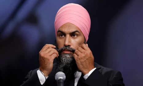 Jagmeet Singh wearing the Sikh dastar and gesturing with both hands at the microphone