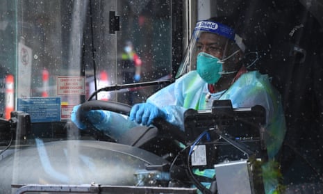 A SkyBus driver dressed in personal protective equipment is seen after dropping passengers off at a hotel quarantine facility at Pan Pacific Melbourne in Melbourne, Monday, 7 December 2020.