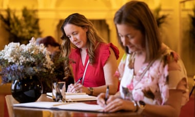 Members of the public sign a book of condolence for the late Queen Elizabeth II at the Government House of Western Australia.