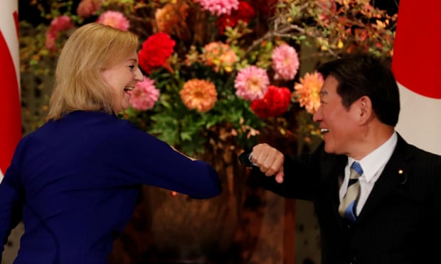 Liz Truss and Japan's Foreign Minister Toshimitsu Motegi bump elbows 