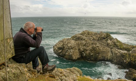 Tim Birkhead looking out to sea with binoculars