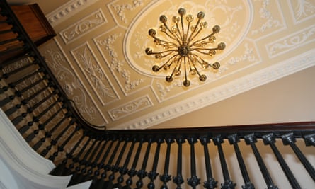 The cantilevered staircase, chandelier and ornate ceiling at Garforth House