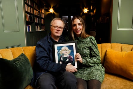 In Memory of Maudie: Jason Watkins and his wife Clara Francis holding a picture of their daughter.