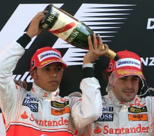 Lewis Hamilton pours champagne on his Mercedes teammate Fernando Alonso after the Spaniard's victory at Monza in 2007.