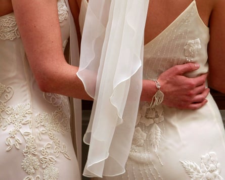 Two women in wedding dresses, seen from behind