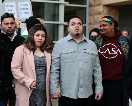 Kilmar Abrego Garcia, whose wrongful deportation to El Salvador made him a symbol of Trump's aggressive immigration policies, holds the hand of his wife Jennifer Vasquez Sura outside court on the day of a hearing in his case in Greenbelt, Maryland.