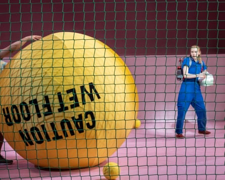 Alex Keenan's Chris is greeted by giant yellow balls at Paddington station.