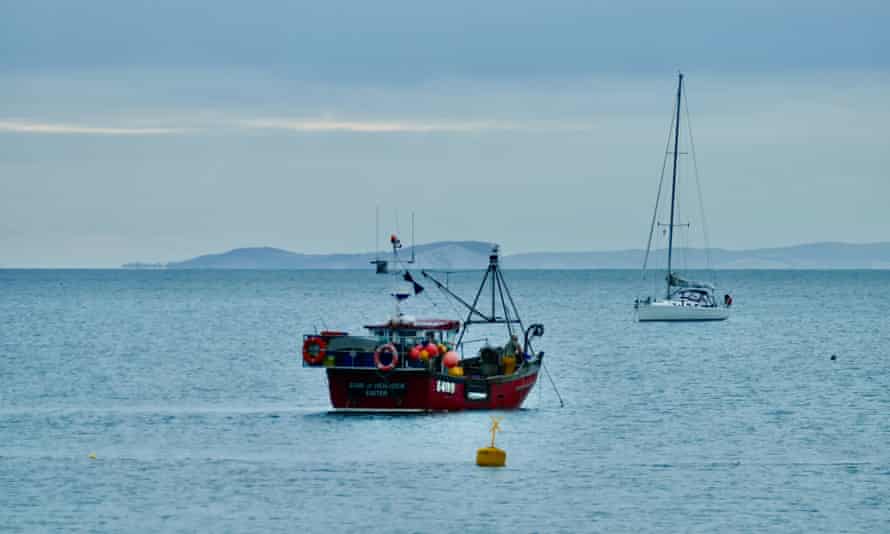 A trawler in Dorset bay on an overcast morning
