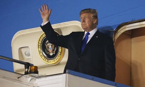 Donald Trump waves as he steps off Air Force One