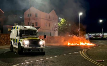 A PSNI vehicle near to debris on fire in Ballymena.